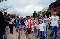 Ministers and members participate in a Good Friday Ecumenical Way of the Cross in St. George