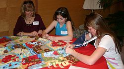 Mothers and daughters pray for newborn infants at retreat 