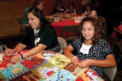 Mothers and daughters pray for newborn infants at retreat 